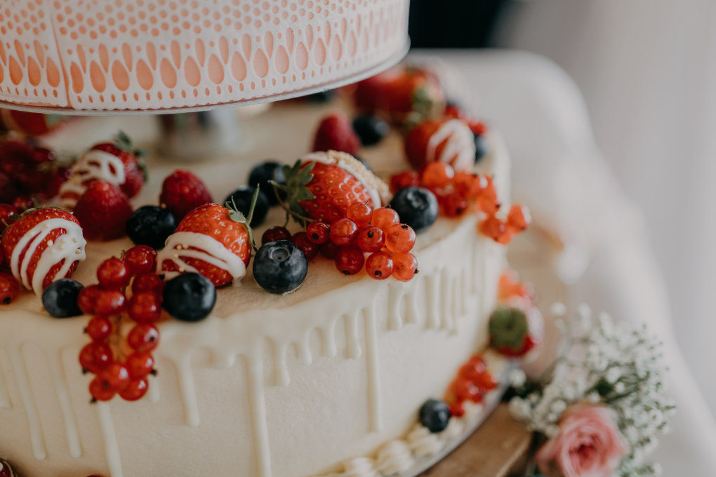 Close-up of an elegant wedding cake decorated with berries - fake wedding cakes