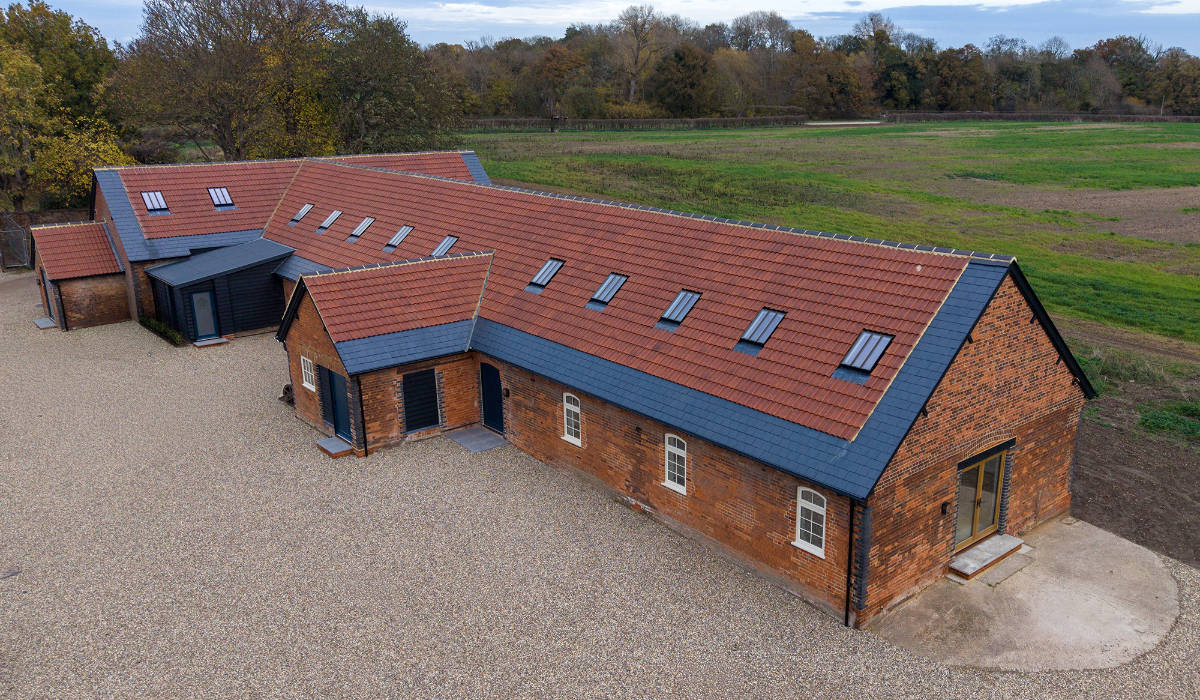 A panoramic view of Woodhall Farmstead in its rural setting