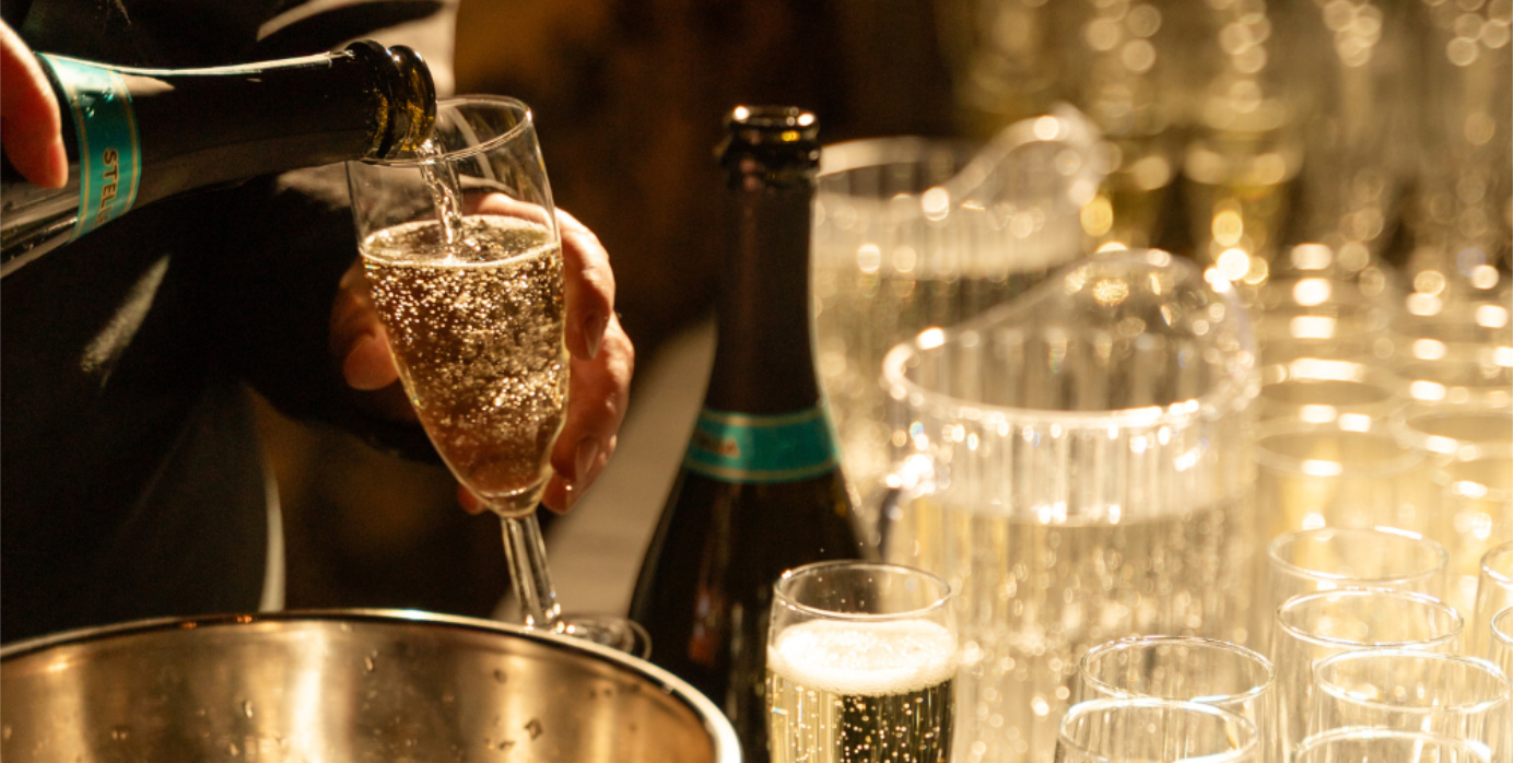 How to Plan Your Work Christmas Party - pouring Champagne